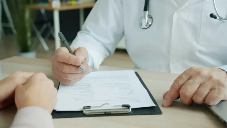 Physician reviewing patient information during a pain management appointment