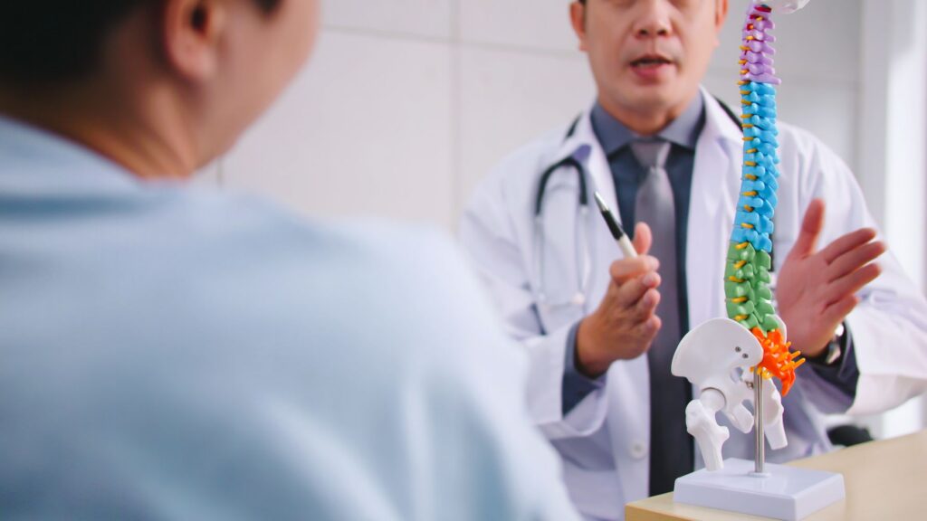 Pain management doctor explaining a spinal condition to a patient